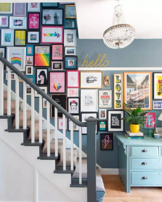 Bright and eclectic stairway gallery with colorful artworks