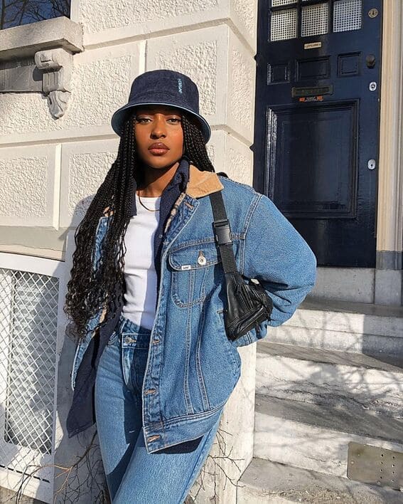 Woman in a casual fall outfit with double denim and a bucket hat. 