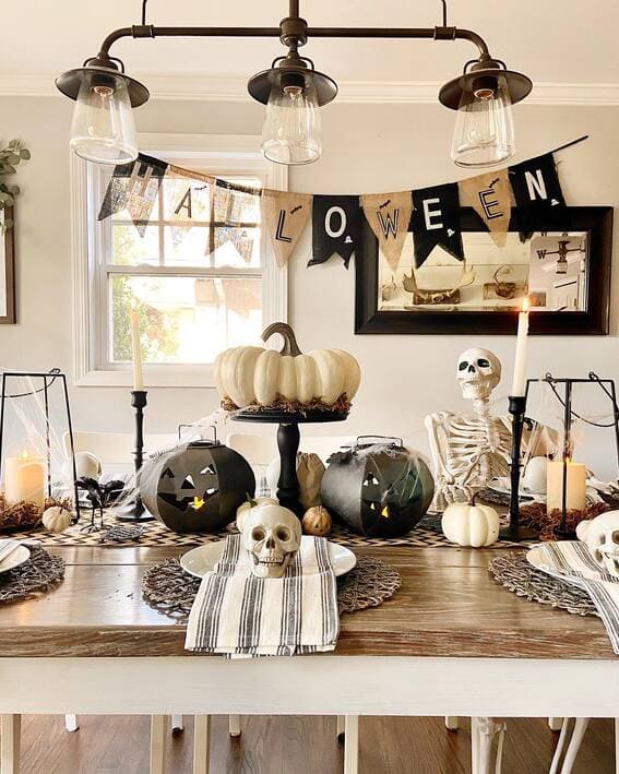 Festive Halloween dining table with spooky skeleton decor. 