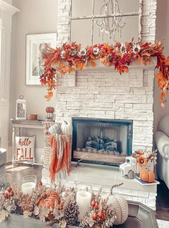 A festive fall mantel adorned with a vibrant garland of colorful autumn leaves, sunflowers, and pinecones, bringing warmth and seasonal charm to the space. 