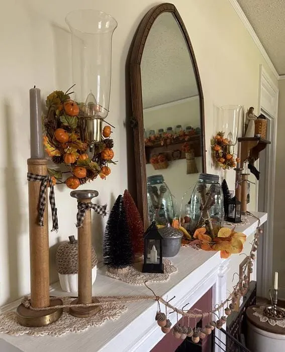 An eclectic fall mantel decor featuring vintage elements and rustic accents. 