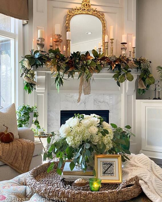 Sophisticated fall mantel with magnolia garland and candles. 