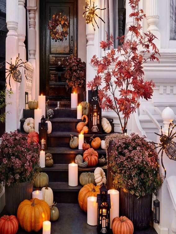 This porch oozes sophistication with its mix of glowing candles and haunting black lanterns that light the way up the stairs. 