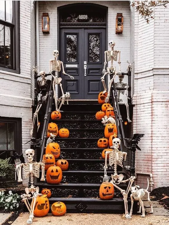 This front porch takes spooky to a new level with a squad of skeletons casually lounging on the steps, surrounded by an array of carved jack-o'-lanterns. 