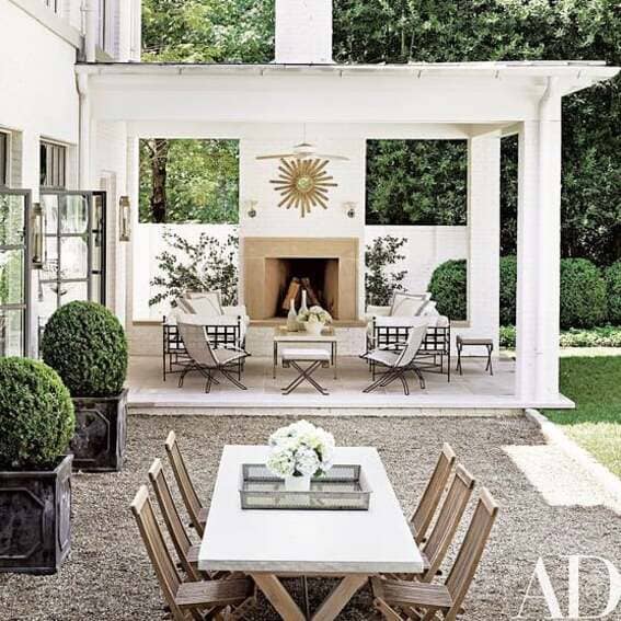 Modern outdoor pavilion with an elegant fireplace as well as a cozy seating area. 