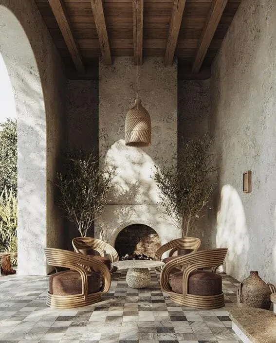 Elegant outdoor nook with a Mediterranean-inspired fireplace and sculptural seating. 