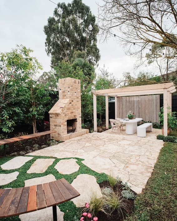 Beautiful backyard patio featuring an impressive brick fireplace as well as comfortable seating area. 