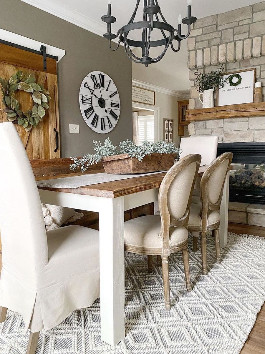 This image is a great idea for a farmhouse dining room featuring a sliding barn door and rustic charm, adding character and functionality to the space.Farmhouse dining room decor inspiration by @thegatewayhome / Instagram