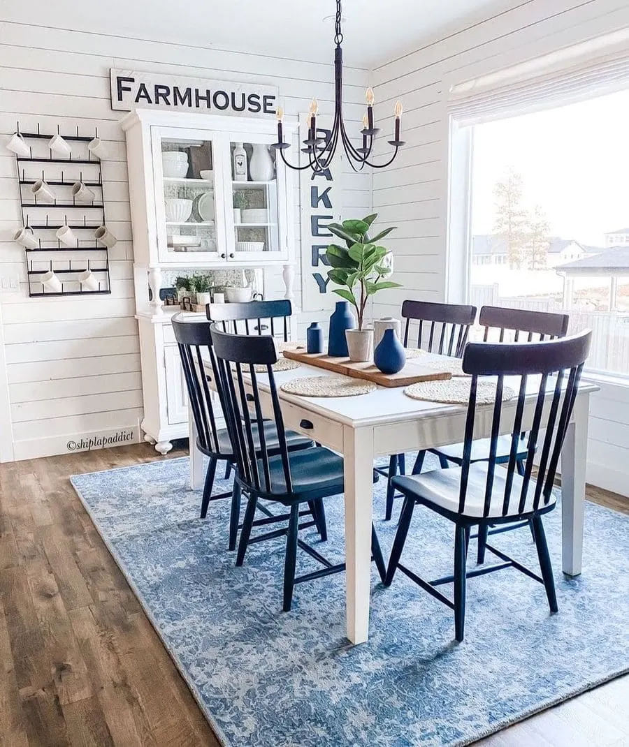 This image is a great idea for creating a cozy farmhouse dining area, with classic country dining chairs and shiplap walls for a traditional farmhouse feel.Farmhouse dining room decor inspiration by @shiplapaddict / Instagram