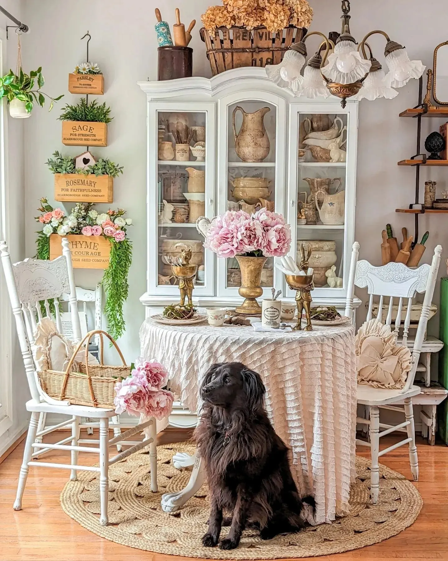 This image is an inspo for a beautifully curated farmhouse dining room, showcasing vintage details, rustic charm, and soft floral touches.Farmhouse dining room decor inspiration by @corbelcottage / Instagram