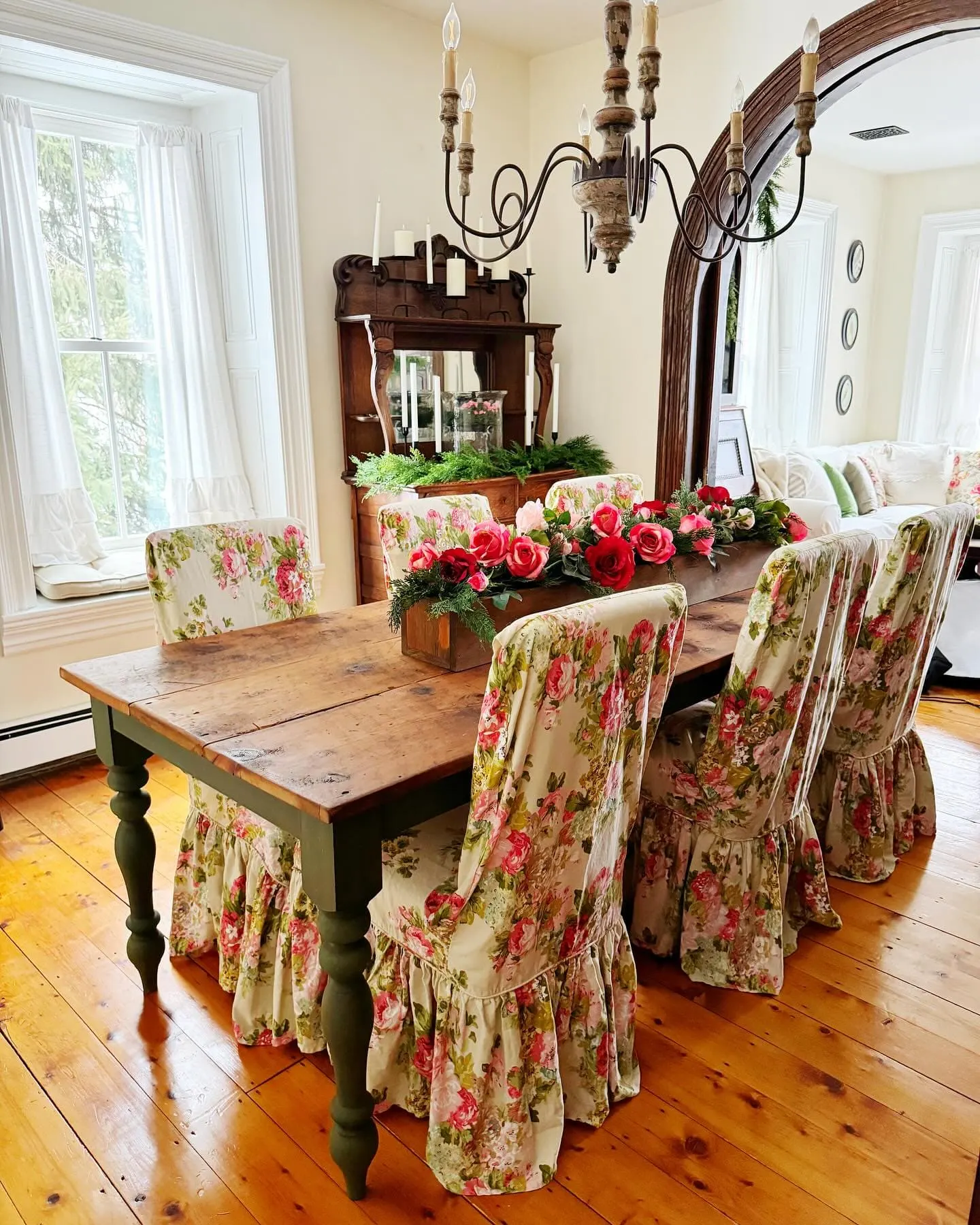 This image is a great idea for farmhouse dining with a mix of rustic furniture, floral slipcovers, and a charming table setup that creates a cozy, welcoming feel.Farmhouse dining room decor inspiration by @our1880farmhouse / Instagram