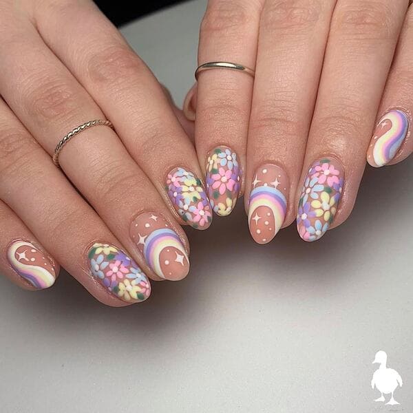 spring nails with pastel flowers, rainbows, and stars