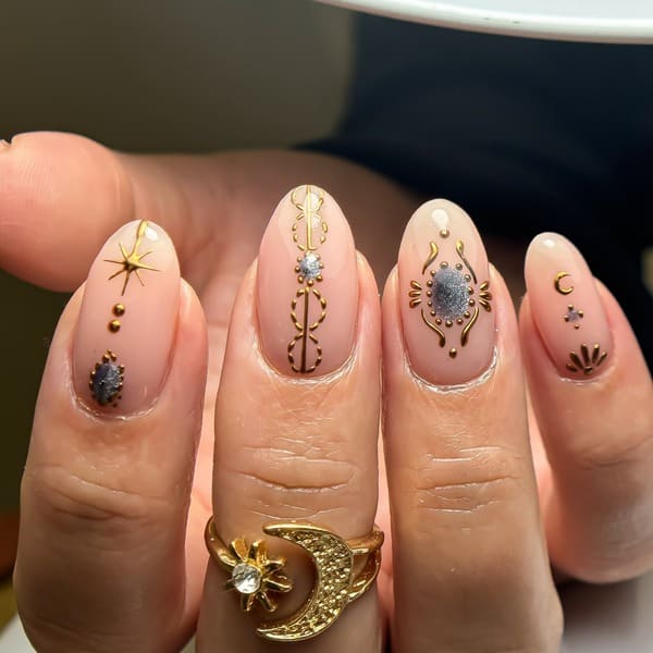 pink nails with gold celestial details