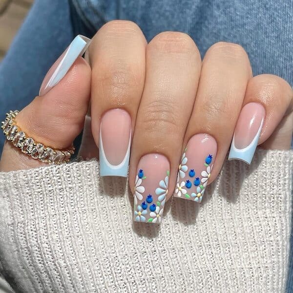 spring nails with white tips and bright blue daisies