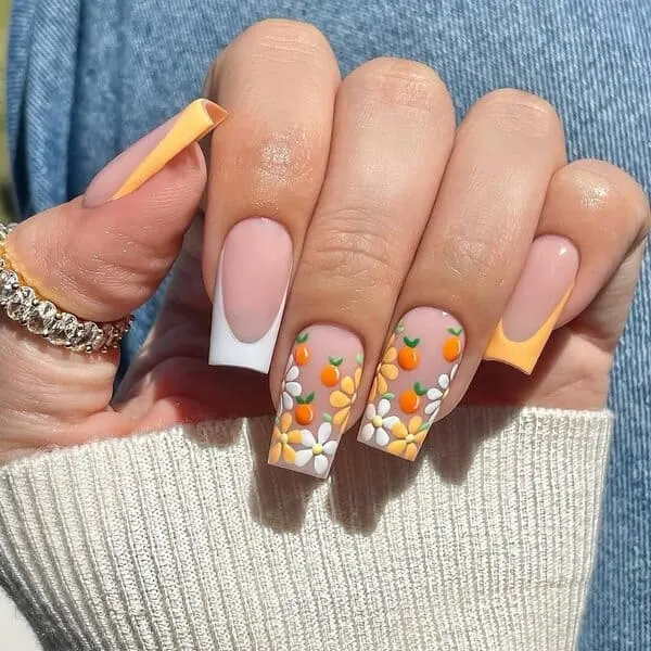 spring nails with orange fruit details and daisies